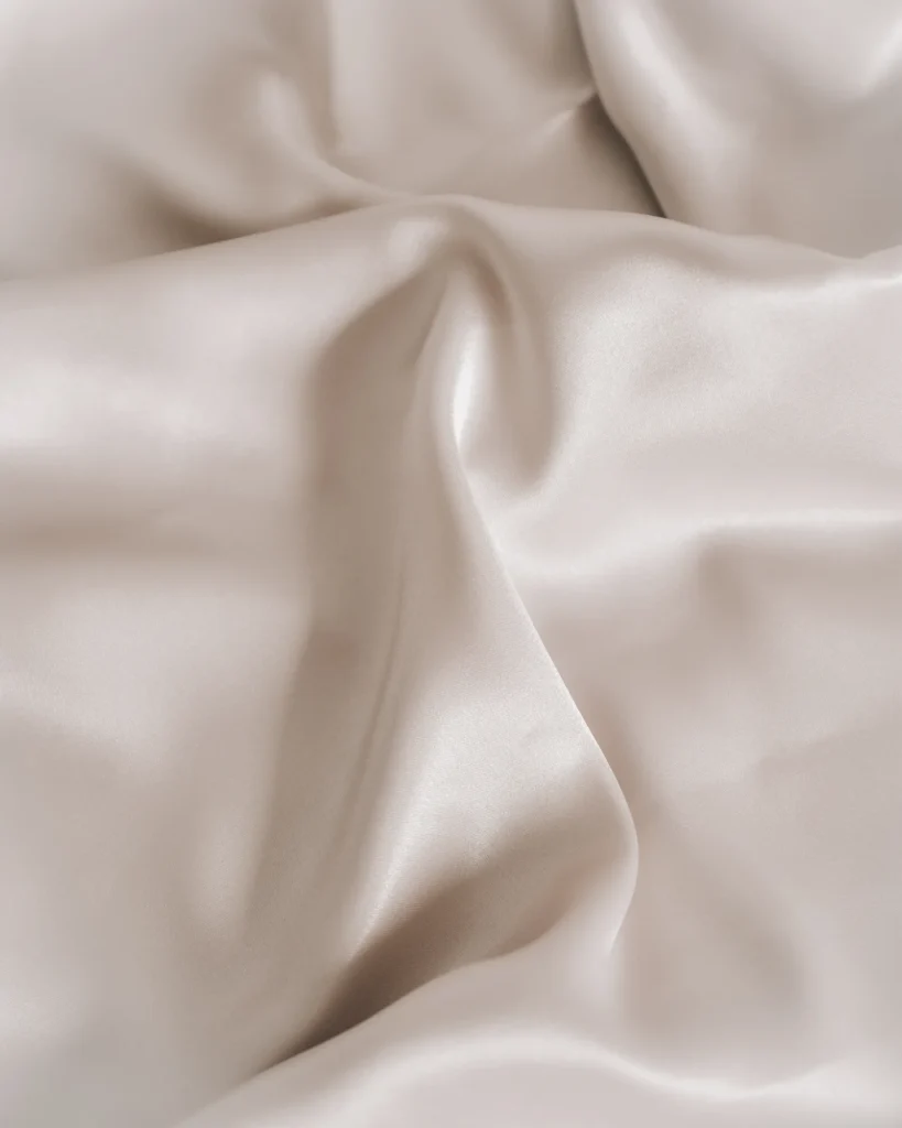 Smooth pale fabric arranged in soft folds