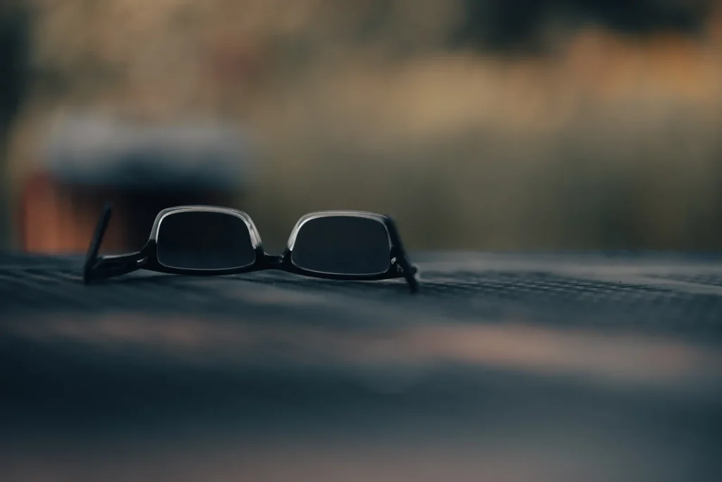 Sunglasses resting on a dark surface