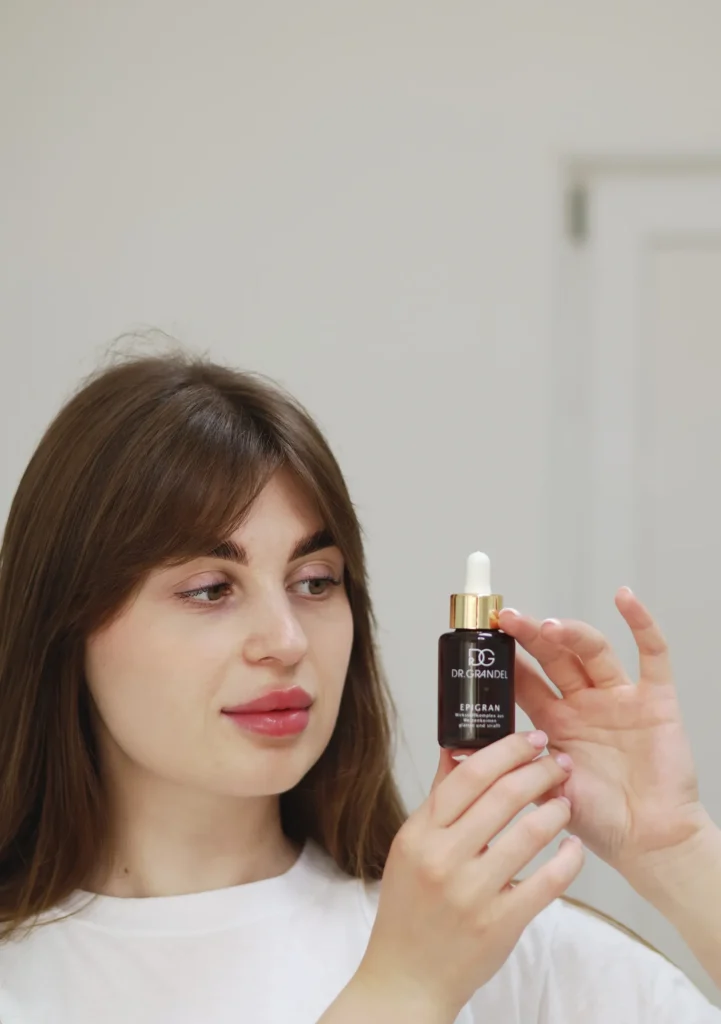 A woman looking closely at a cosmetic bottle