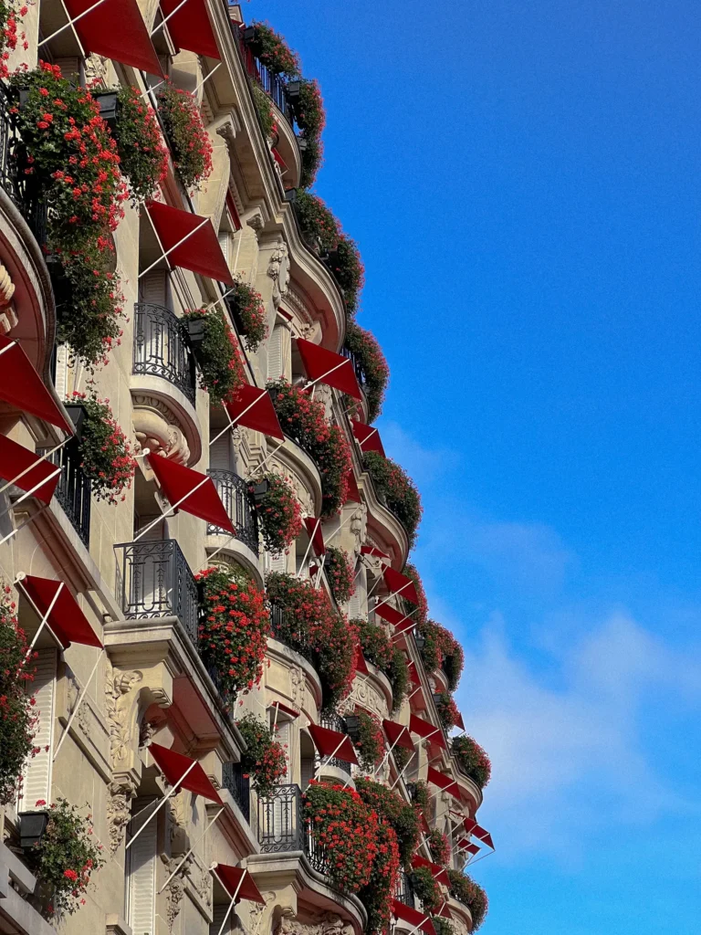 The Paris hotel Plaza Athénée façade with red awnings