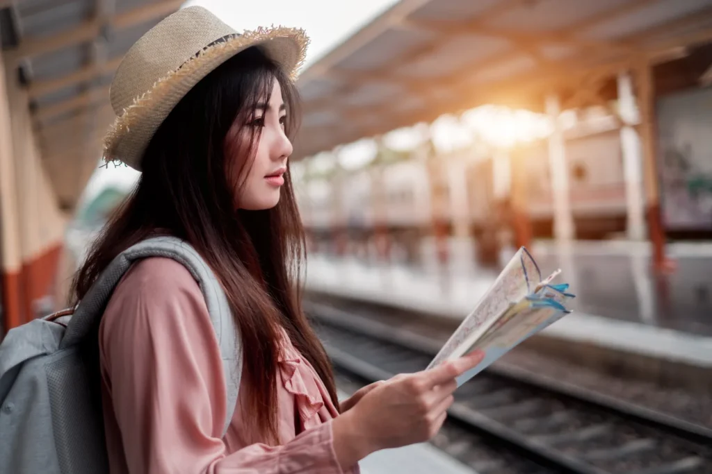 A woman checking a map on a railway platform